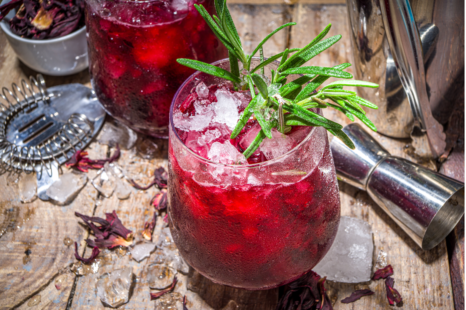 A beautifully illustrated serving suggestion for hibiscus iced tea with fresh mint and ice.