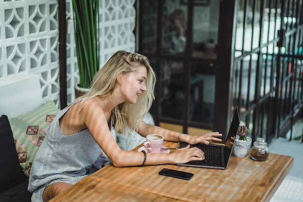 A girl is using a laptop in a cafe