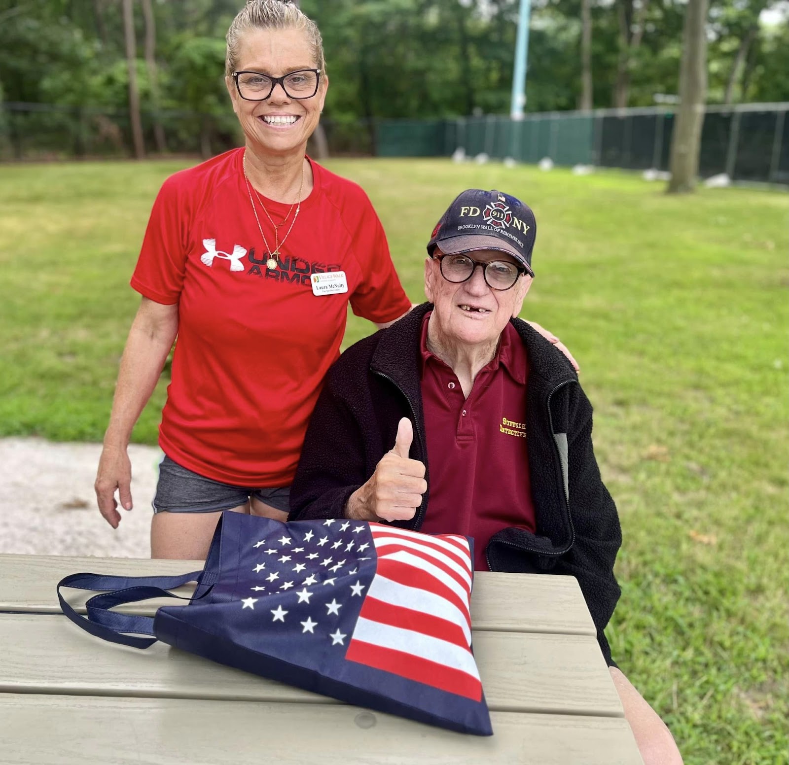 A senior living care worker with an elderly man