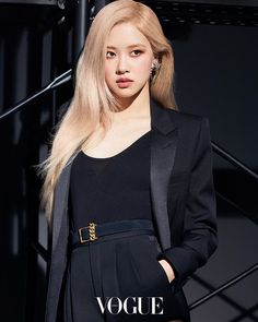 This  contain an image of BLACKPINK Rosé with long blonde hair standing in front of a black wall wearing a suit