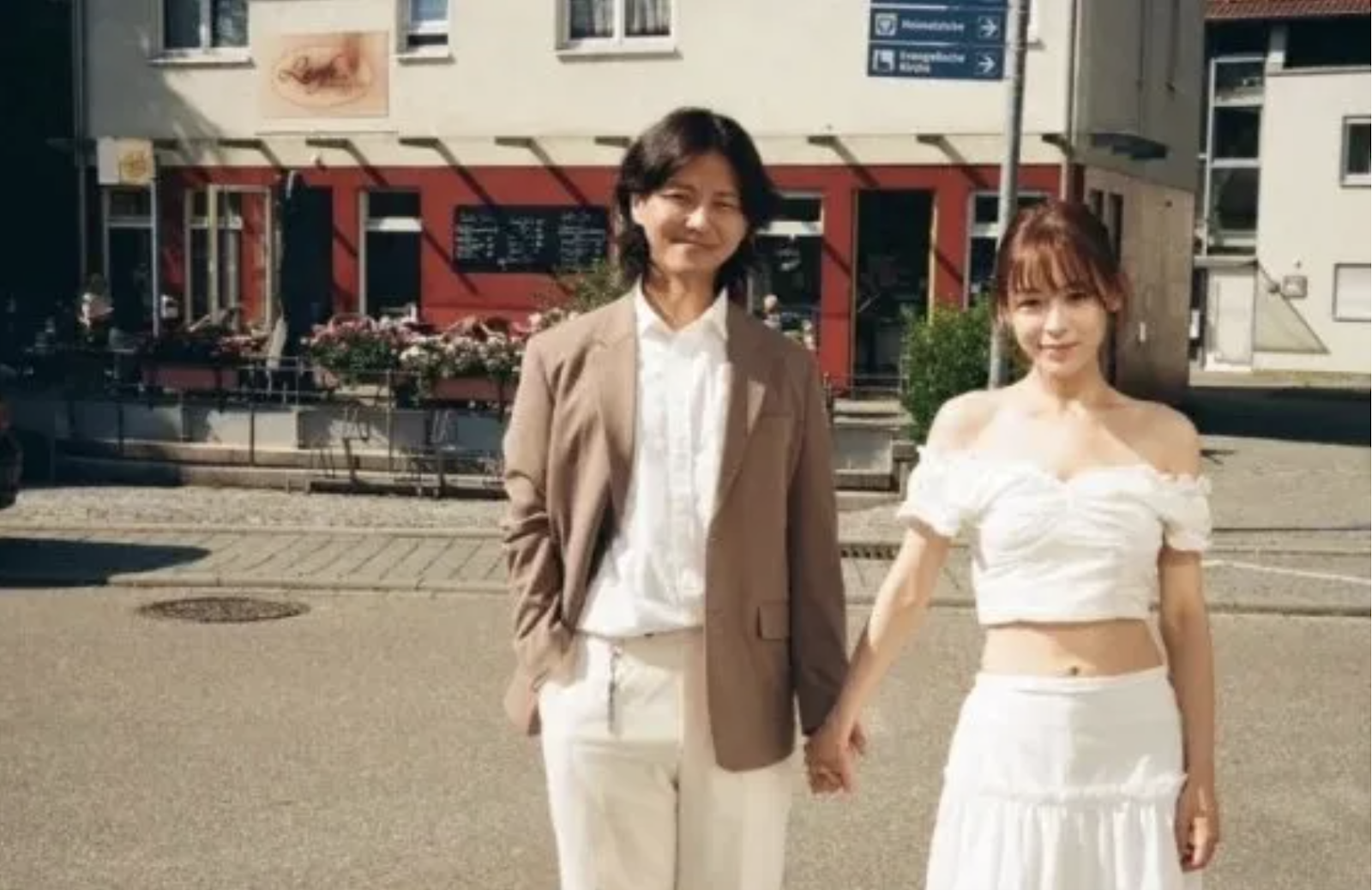 Kim Hyun Sung and Monika holding there hands