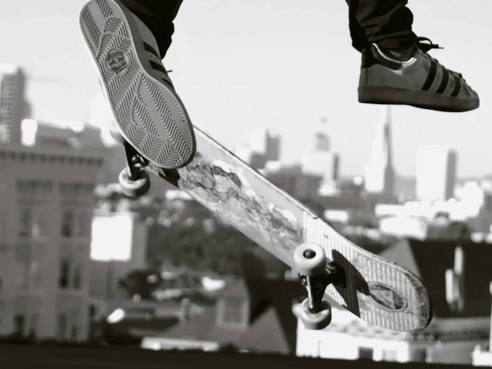 Close-up of a skateboard mid-air during a trick, emphasizing the importance of staying safe while skateboarding through proper techniques and gear.