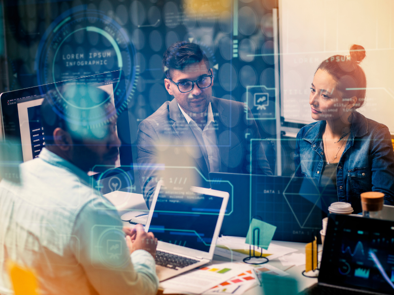 Business team discussing no-code agent development in a meeting room, surrounded by data and AI interface elements