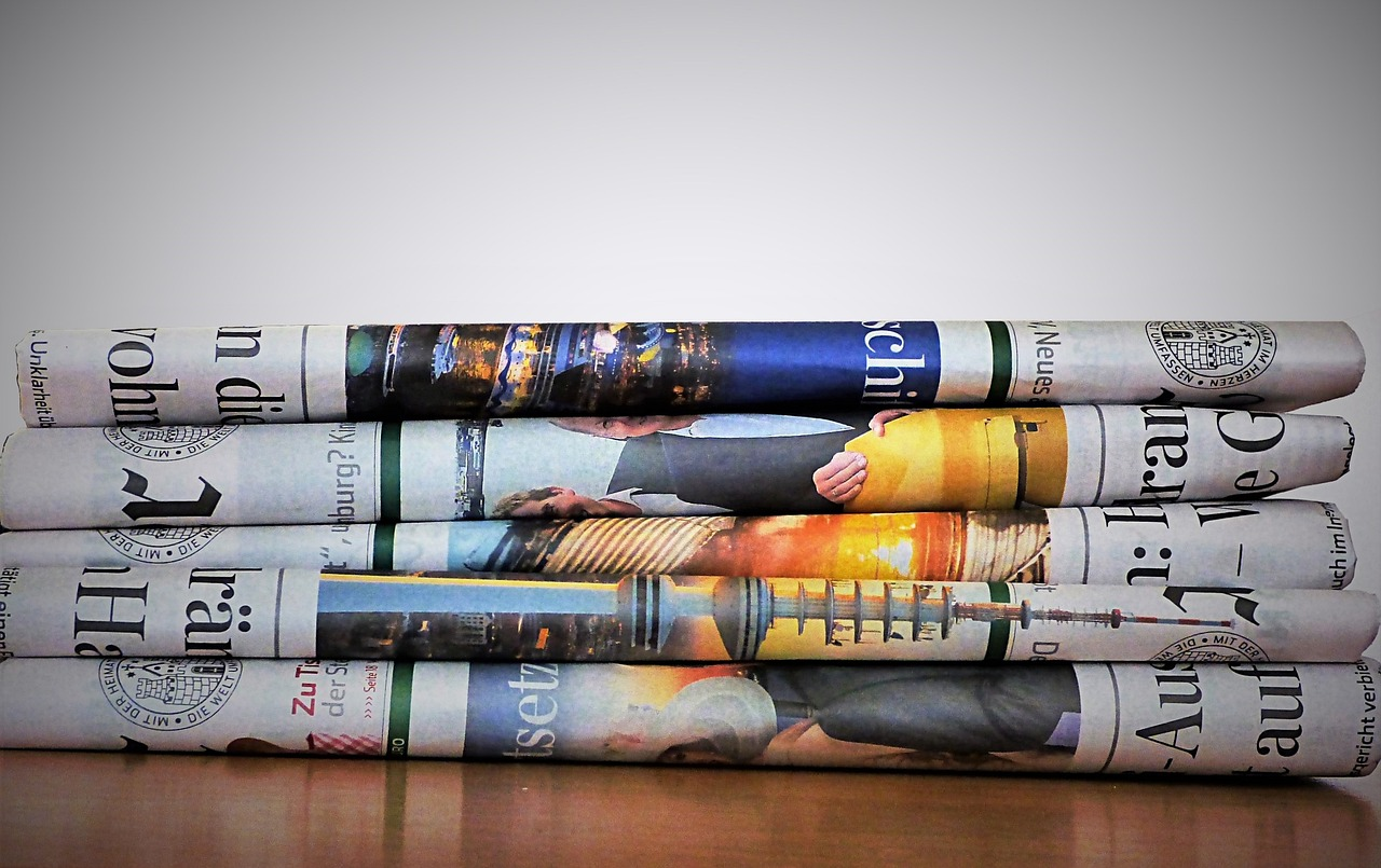 A stack of folded newspapers