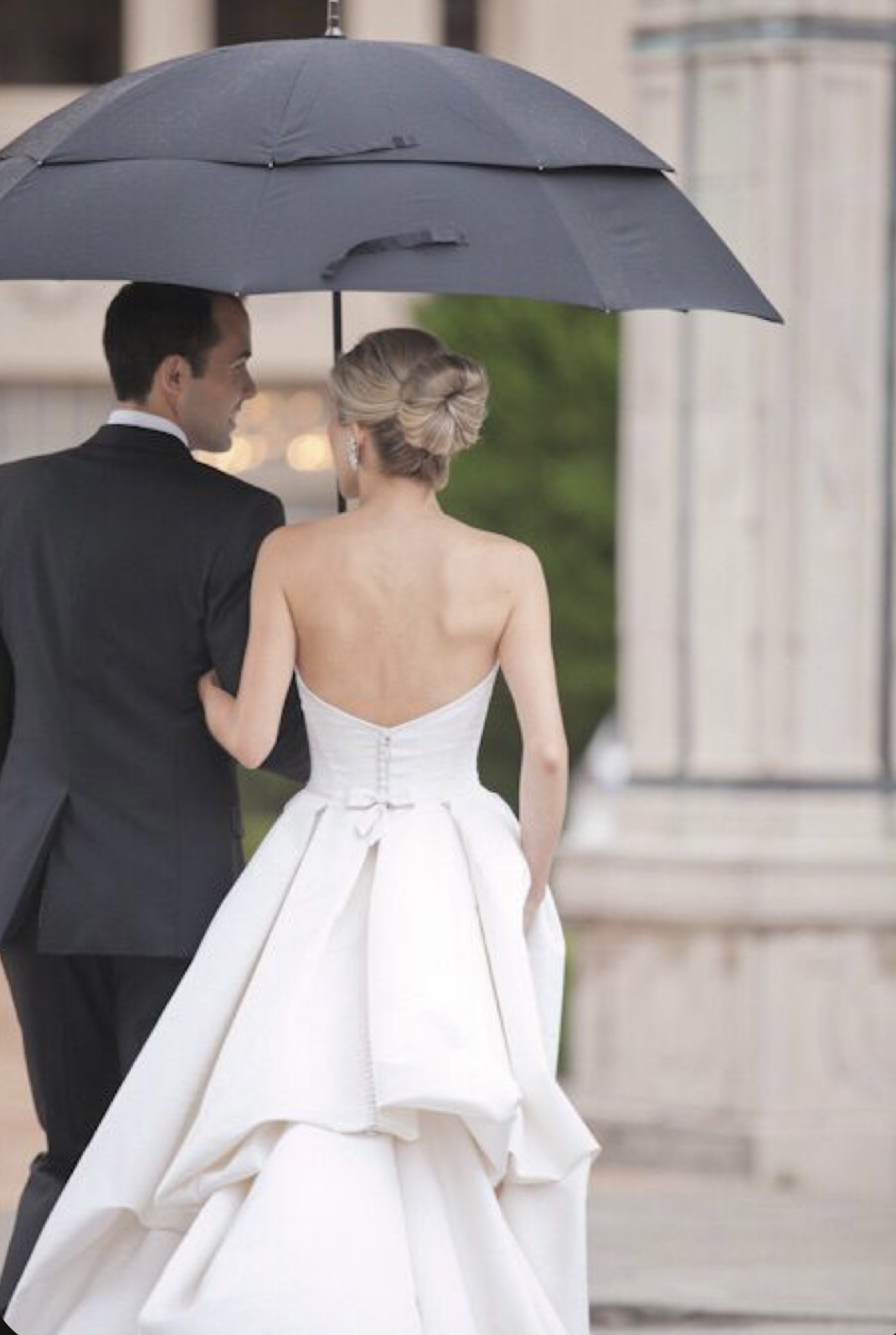 couple under umbrella after wedding day