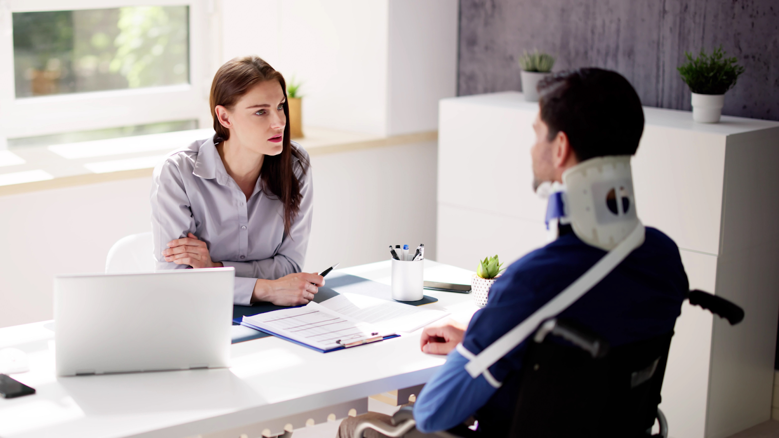 (injured man consulting a lawyer)