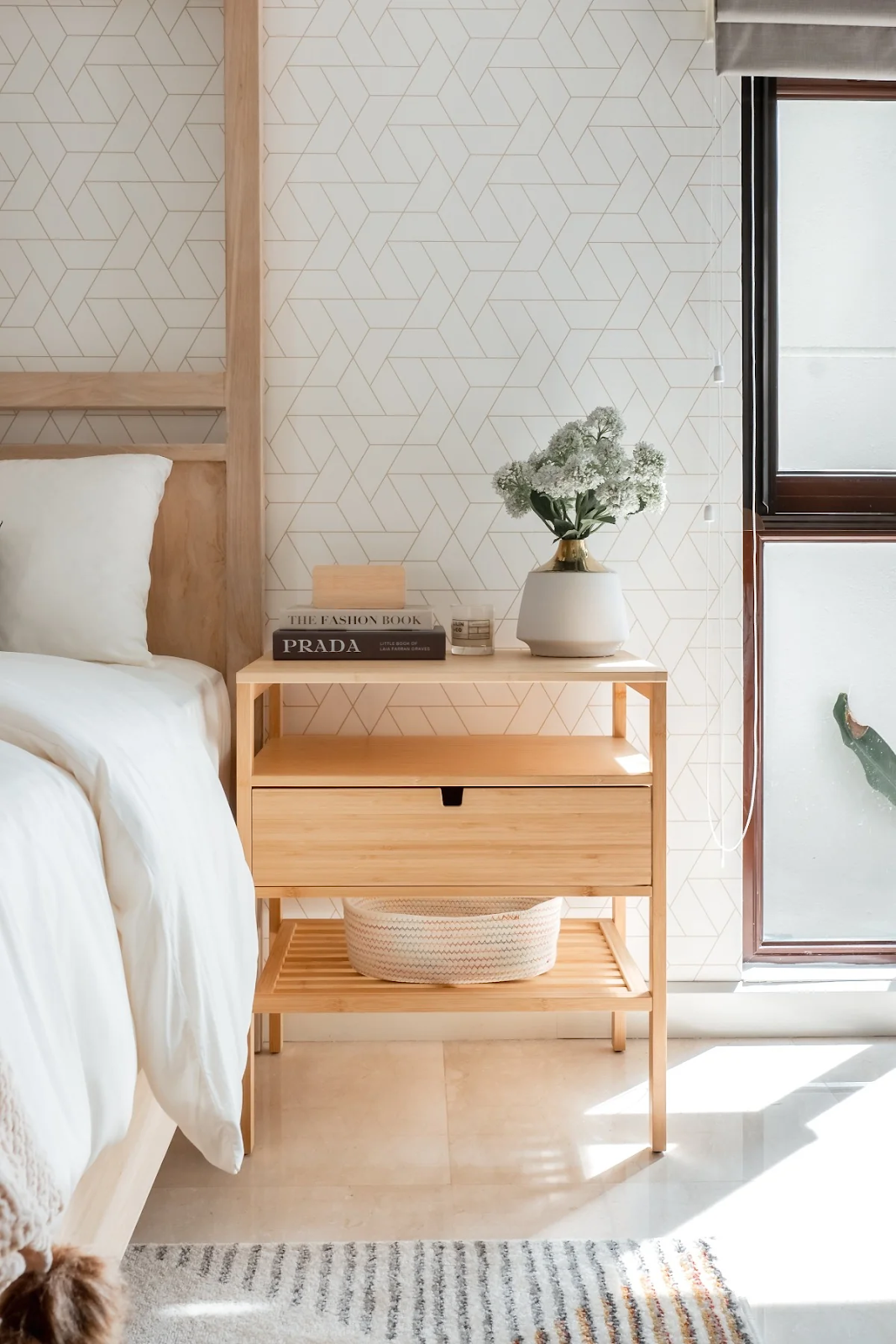 geometric wallpaper in bed room with wooden side table