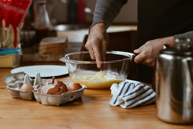 Woman baking in the kitchen, enjoying the process of creating homemade treats.