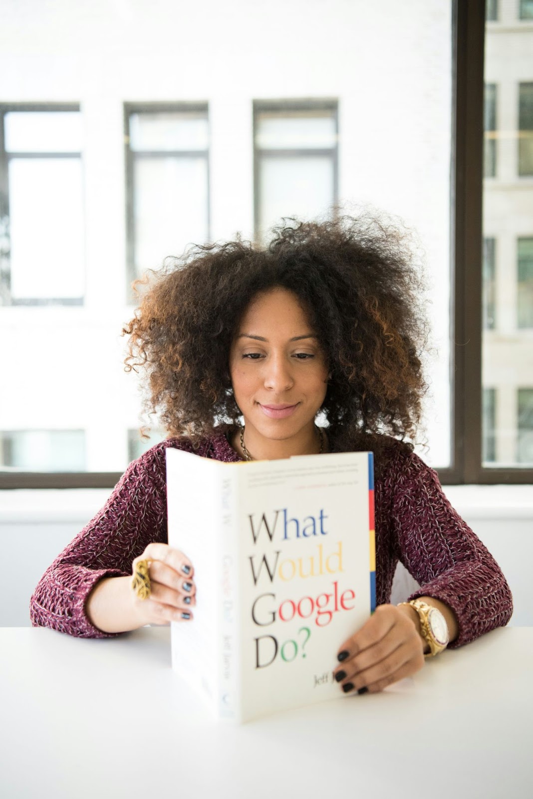 woman reading a book about Google