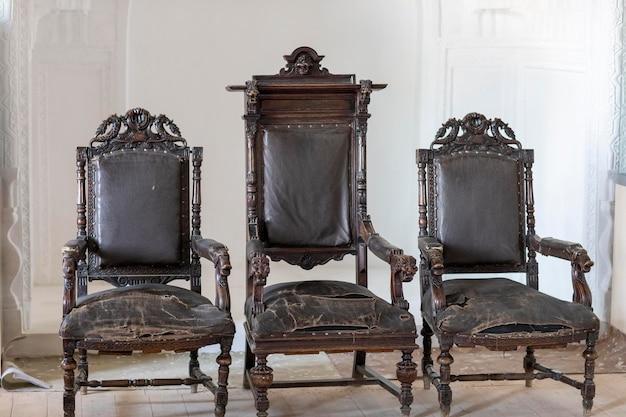 Three black wooden chair in a historical place