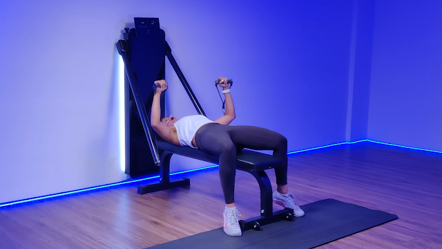 A woman performing push-ups on an all-in-one workout machine, highlighting its functionality for upper body strength and full-body workouts.