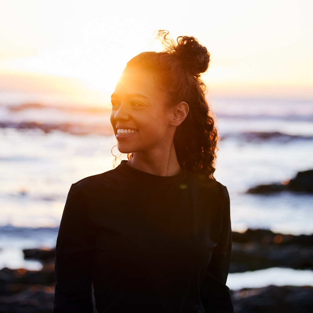 Picture of a woman smiling and looking happy.