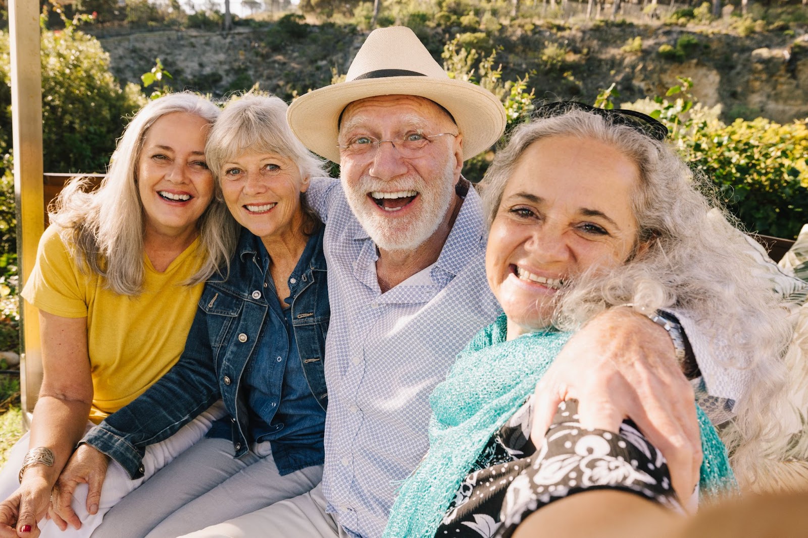 An excited group of seniors taking a selfie while on a trip to the park