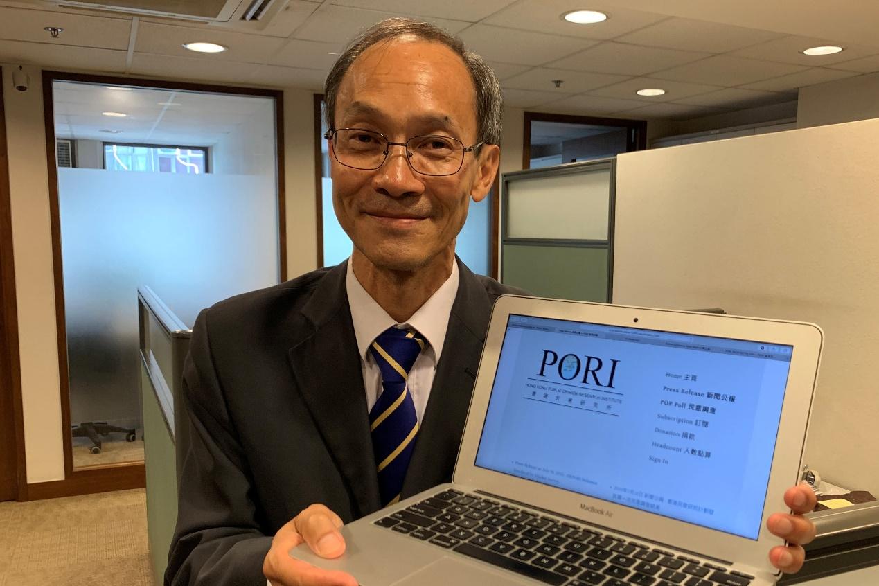 President and CEO of Hong Kong Public Opinion Research Institute (PORI), Robert Chung, holds a laptop showing the website of PORI during a HKPOP news conference in Hong Kong, China July 16, 2019. REUTERS/Joyce Zhou