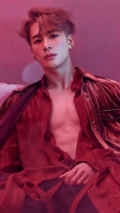 This  contain an image of  Jackson with no shirt sitting on a couch in front of a pink background