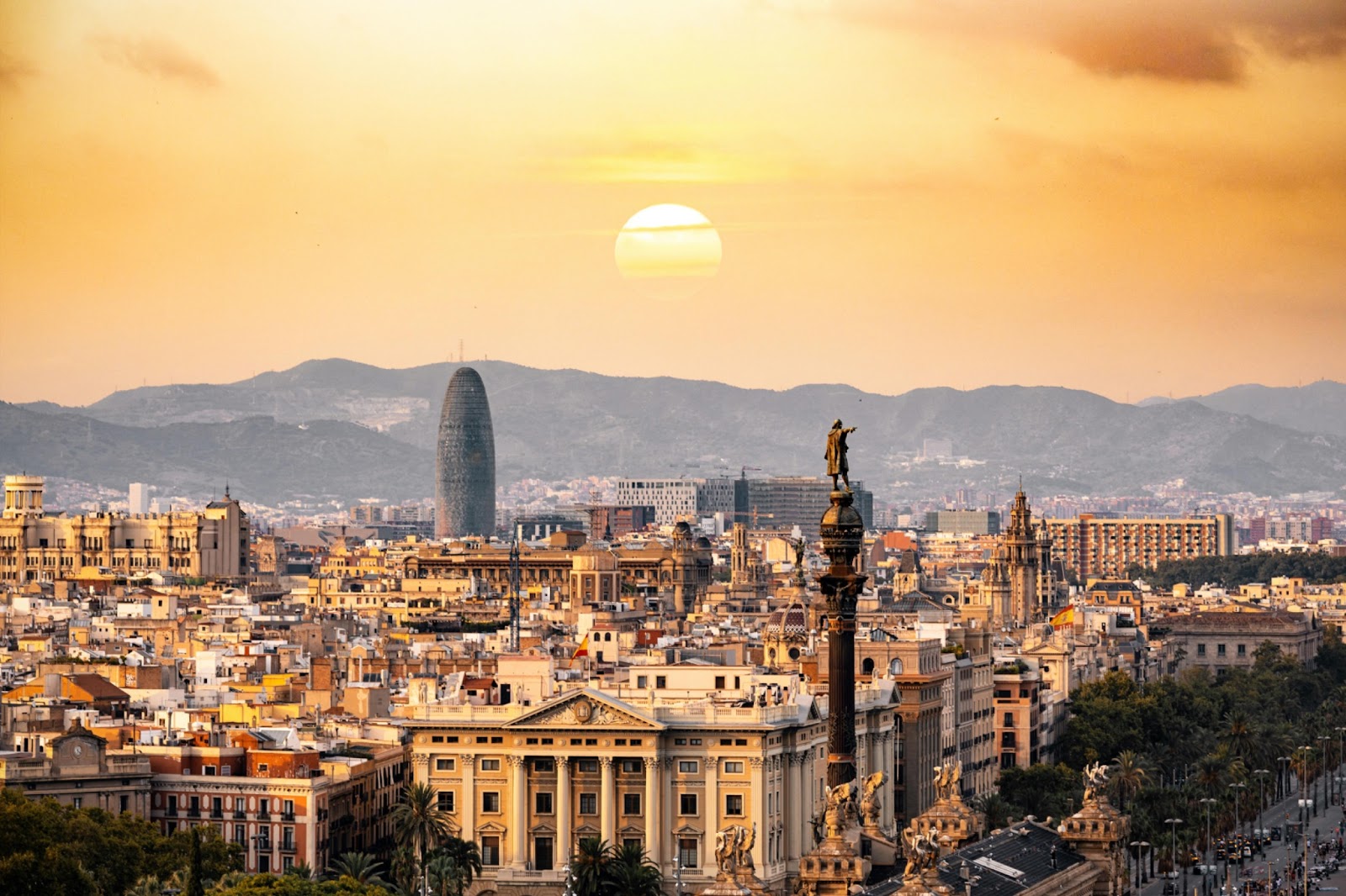 A view of Barcelona city with a sunset backdrop