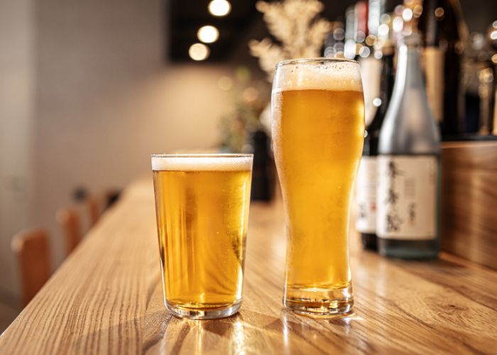 Two glasses of Japanese beer placed on the bar counter