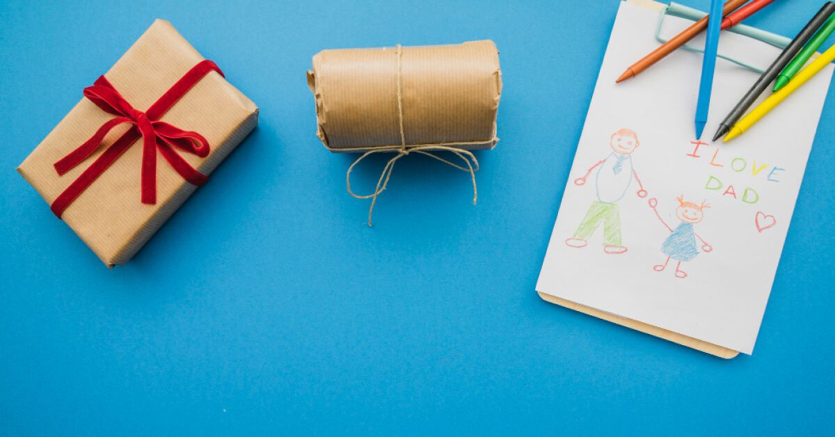 Wrapped gifts next to a notepad and crayons