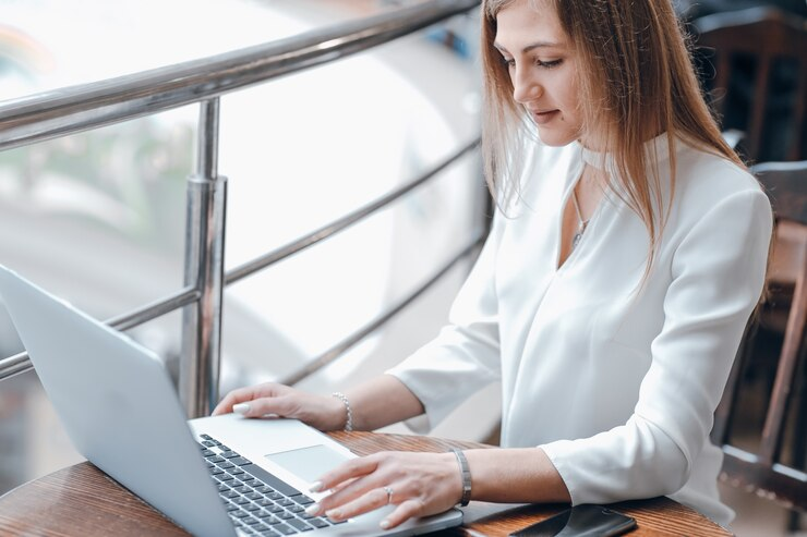 A woman typing on a laptop