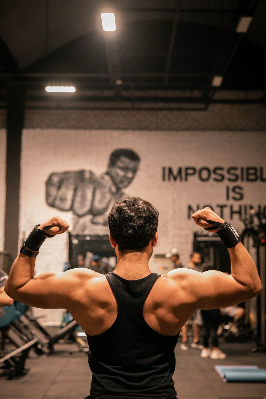 A person in a black vest with his arms up.