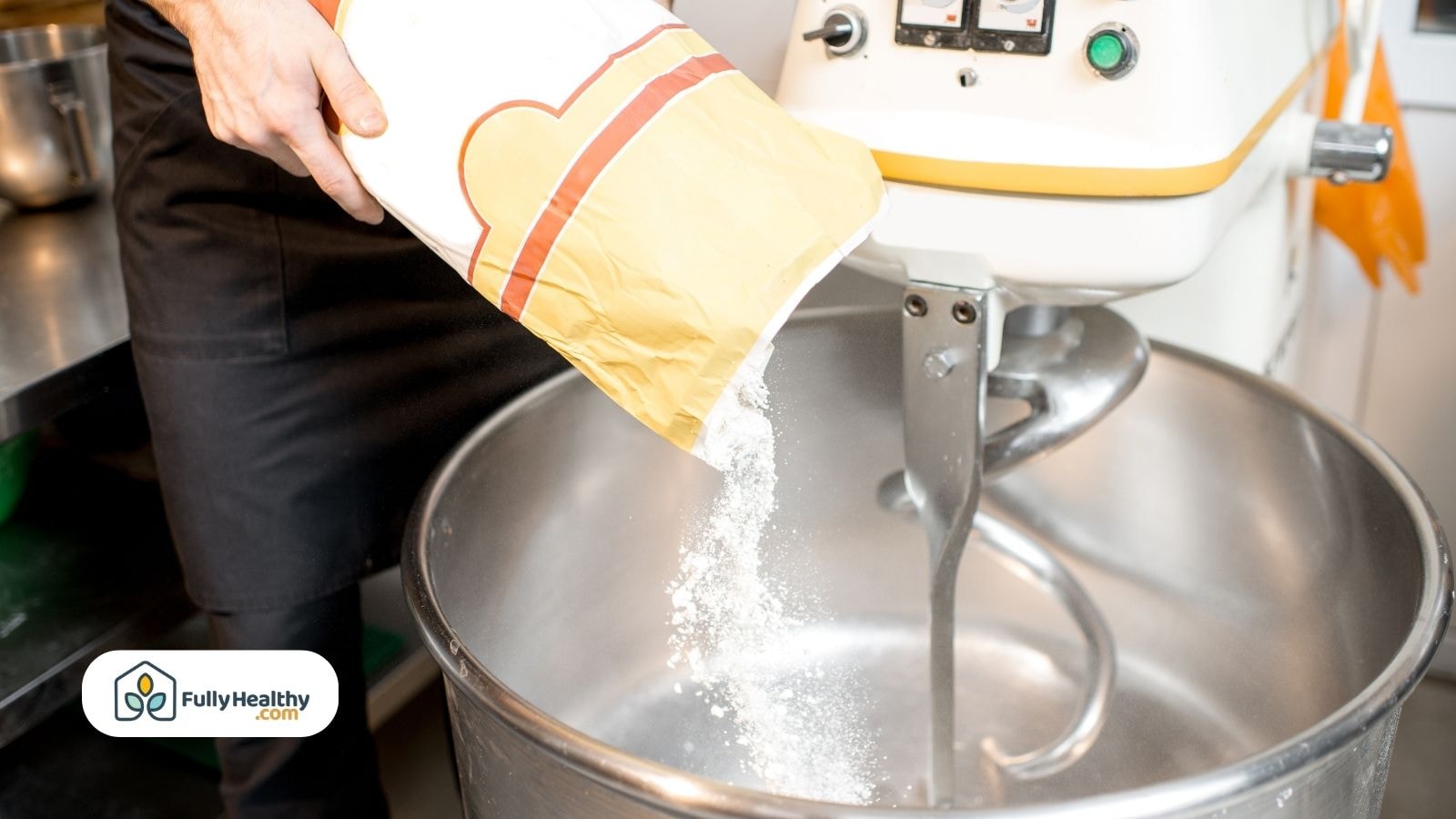Pouring flour into industrial dough mixing machine