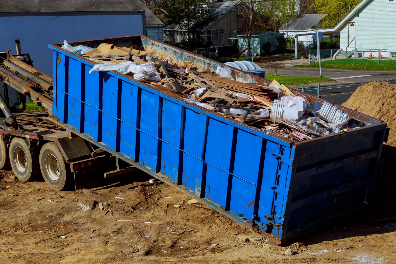 Dumpster on the back of a truck. 
