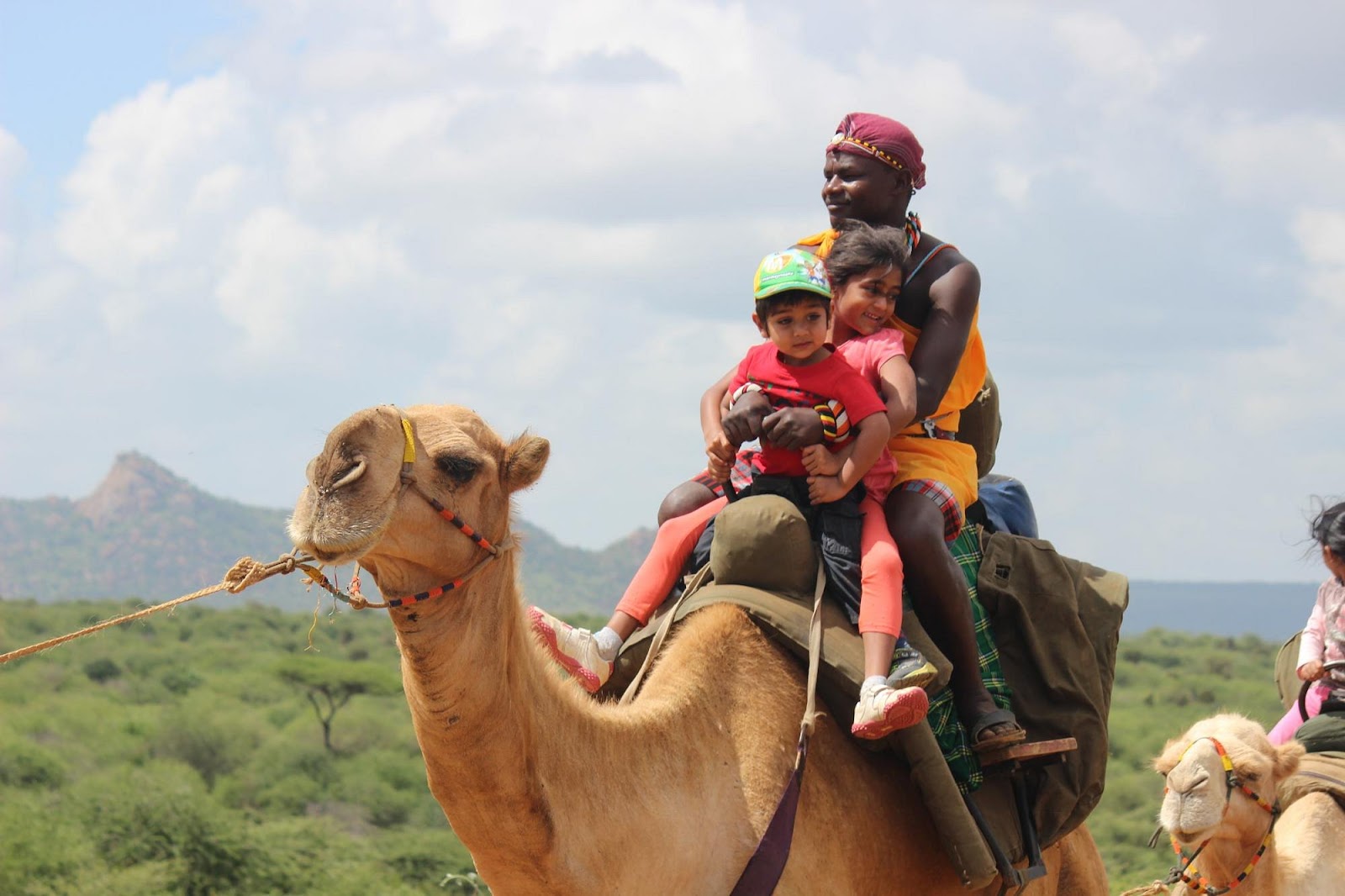 Children riding a camel during Karisia Walking Safaris