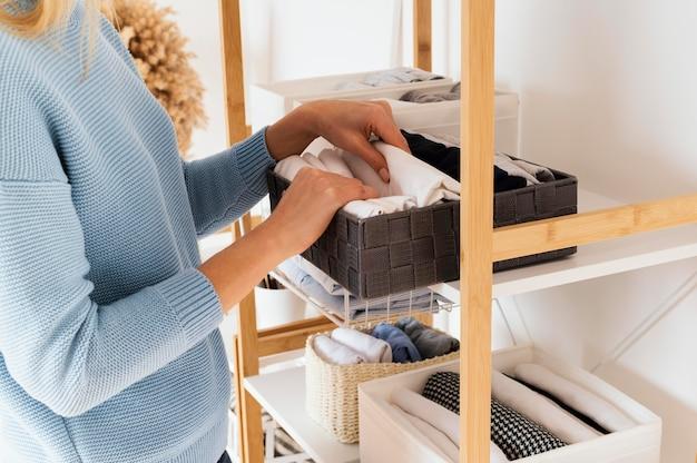lady using storage in a bedroom