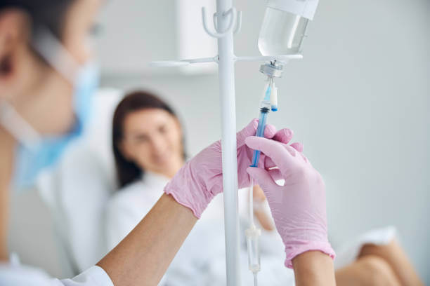 A healthcare expert carefully administering NAD+ IV therapy to a patient, showcasing precision and care in a modern clinical environment.