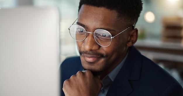 Premium Photo | Happy businessman and reading email on computer in office  with a smile for feedback or online communication black man thinking or  happiness for working with research inspiration or ideas