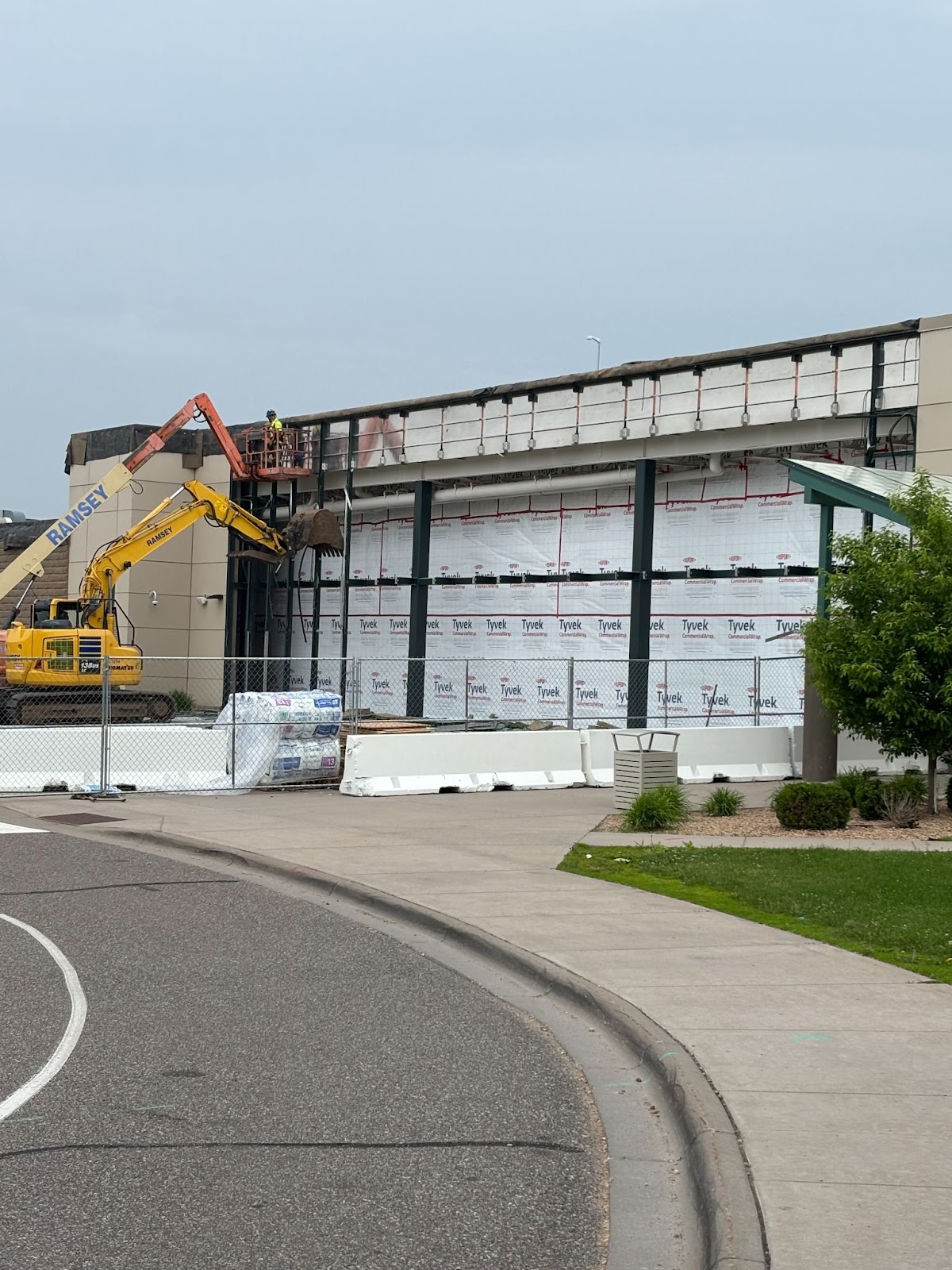 A construction site with a building and a road