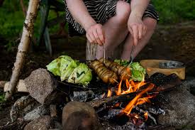 DIY skewers from green branches used as a technique A tin can designed  into a stove used as emergency cooking hacks when camping