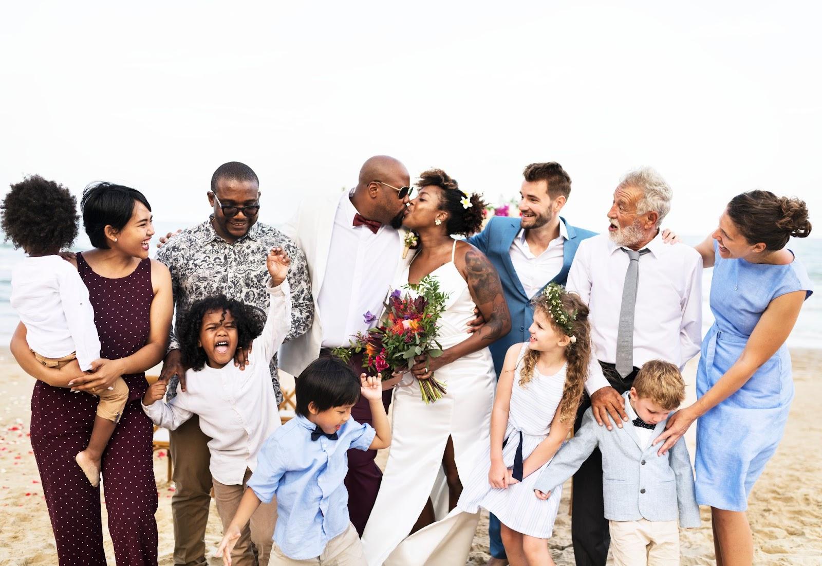 A group of people kissing on the beach

Description automatically generated