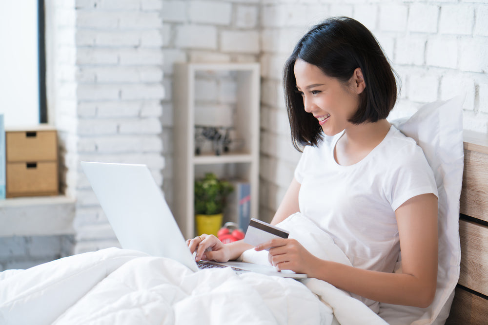 woman ordering surgery recovery pillow from bed