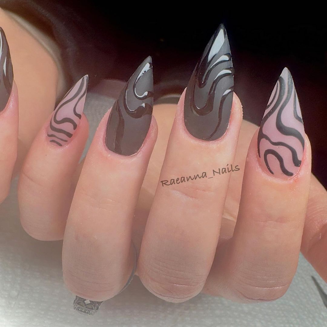 Close-up of a person's hands with black nails having Raised Black Patterns