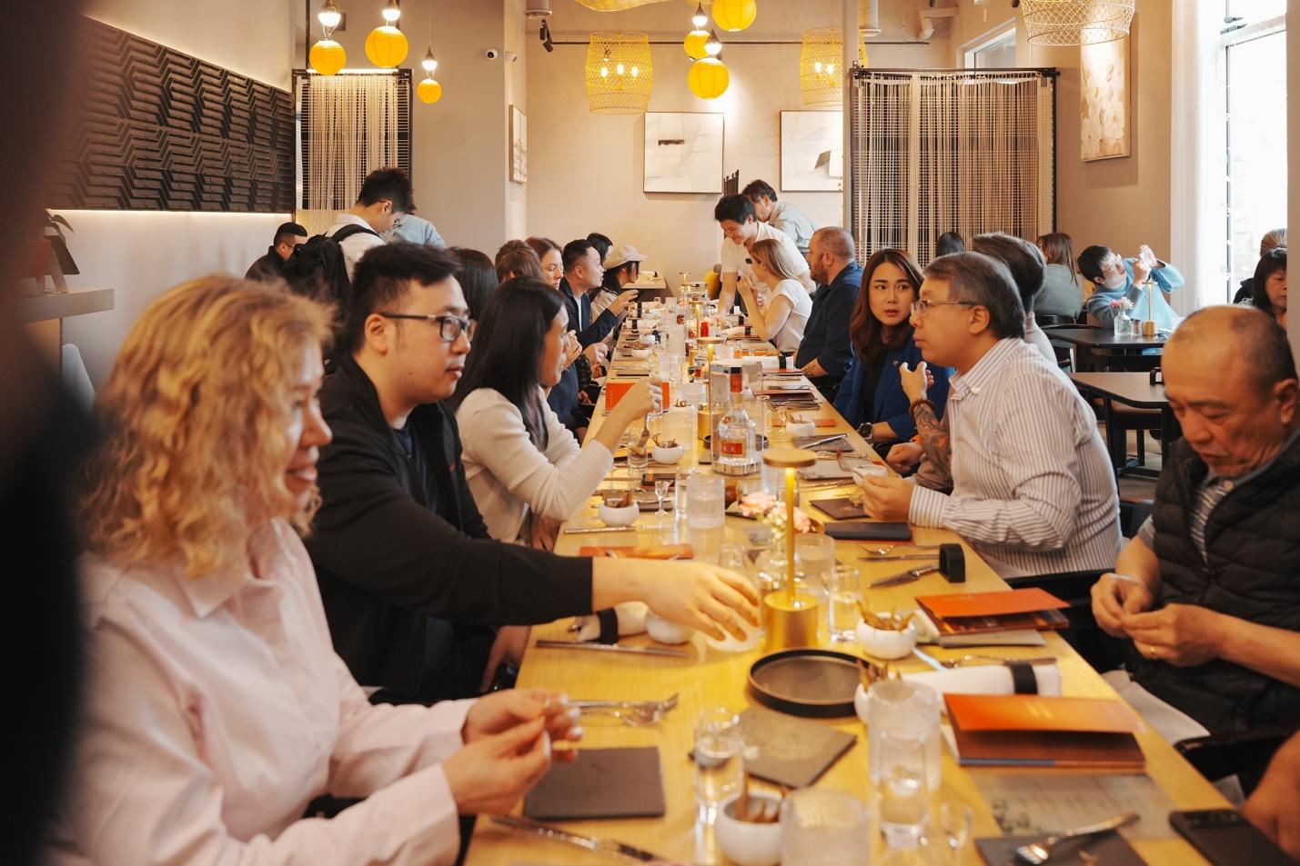 A group of people sitting at a long table

AI-generated content may be incorrect.