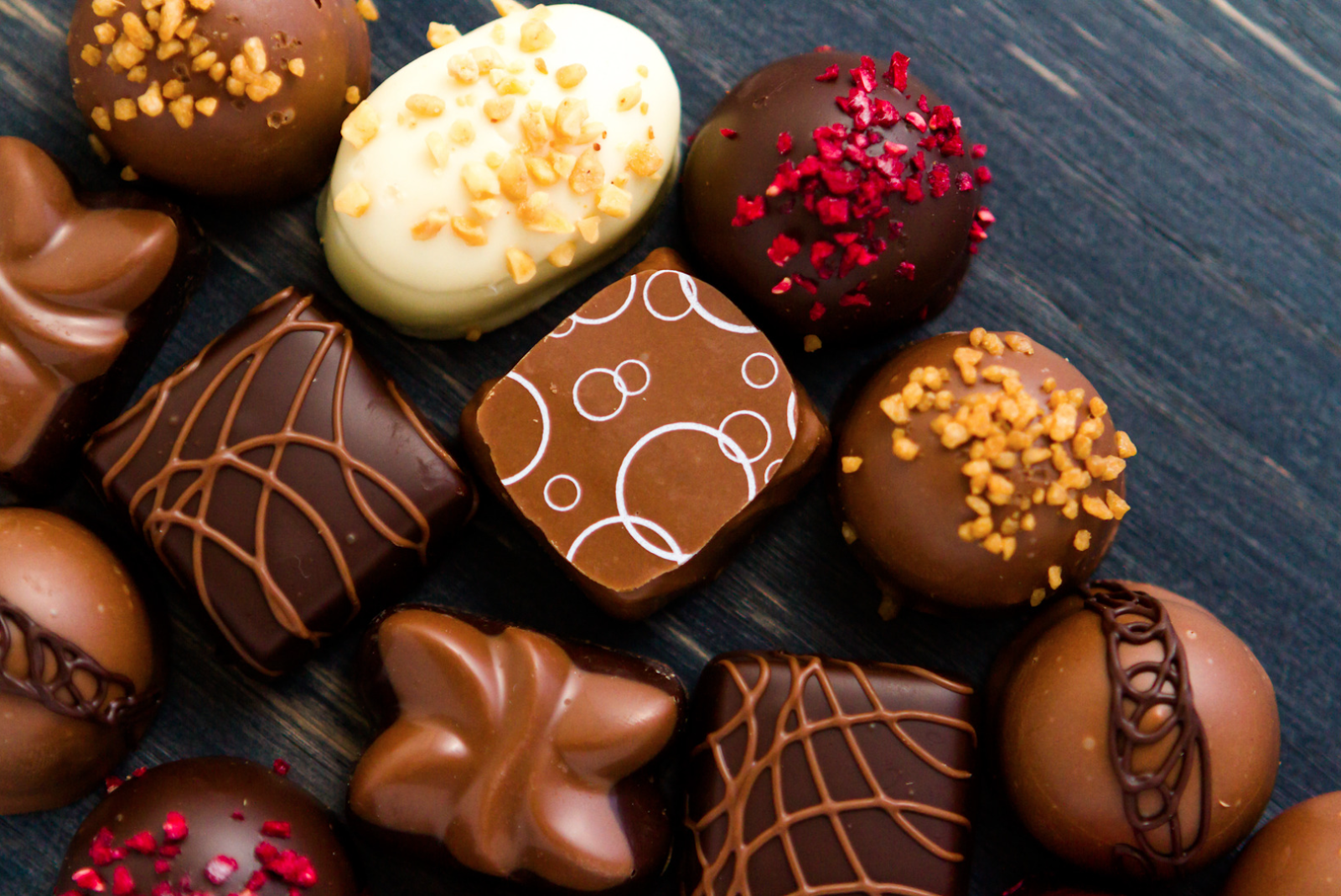 A display of handcrafted artisan chocolates made with high-quality cocoa beans and exquisite designs.