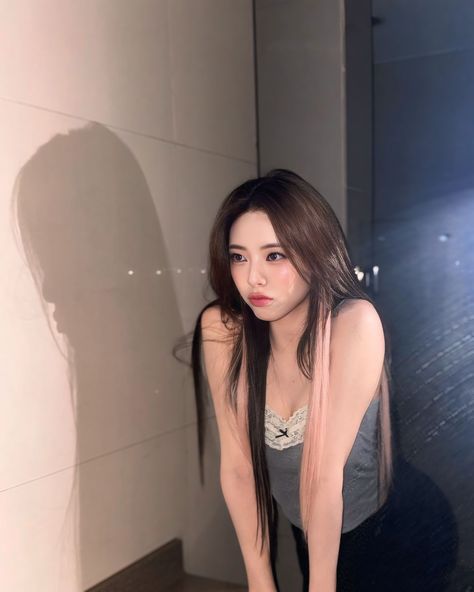 This  contain an image of ITZY Yuna standing next to a toilet in a bathroom