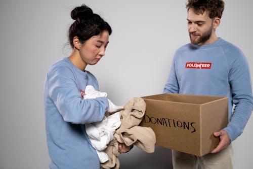 Free Woman Holding Clothes For Donations Stock Photo