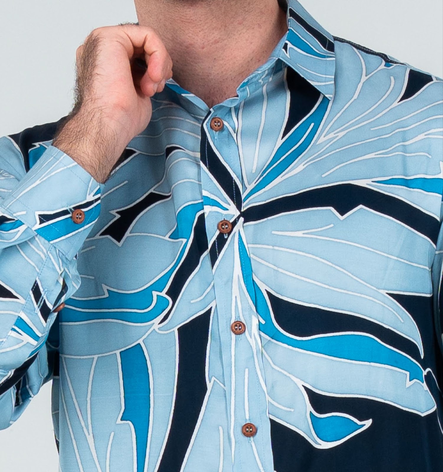 A closeup image showing long sleeved men's batik shirt in moonlight palma from batik boutique, standing in a office