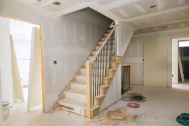 how tariffs will affect your home remodeling project stairs and foyer under construction during remodel custom built michigan
