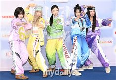 This contain an image of NewJeans posing together in colorful outfits