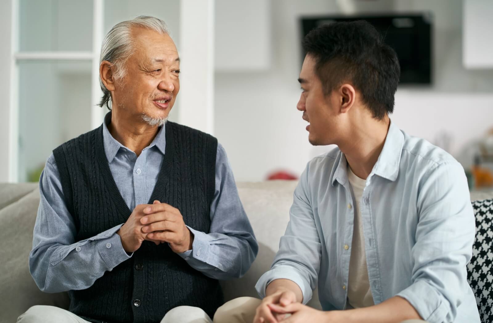 An adult waits patiently for their senior parent to respond to an open-ended question.