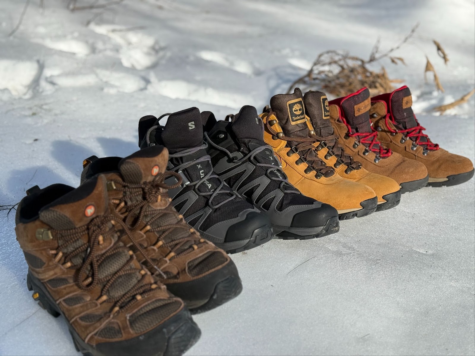 All Of The Best Budget Hiking Boots Lined Up In The Snow