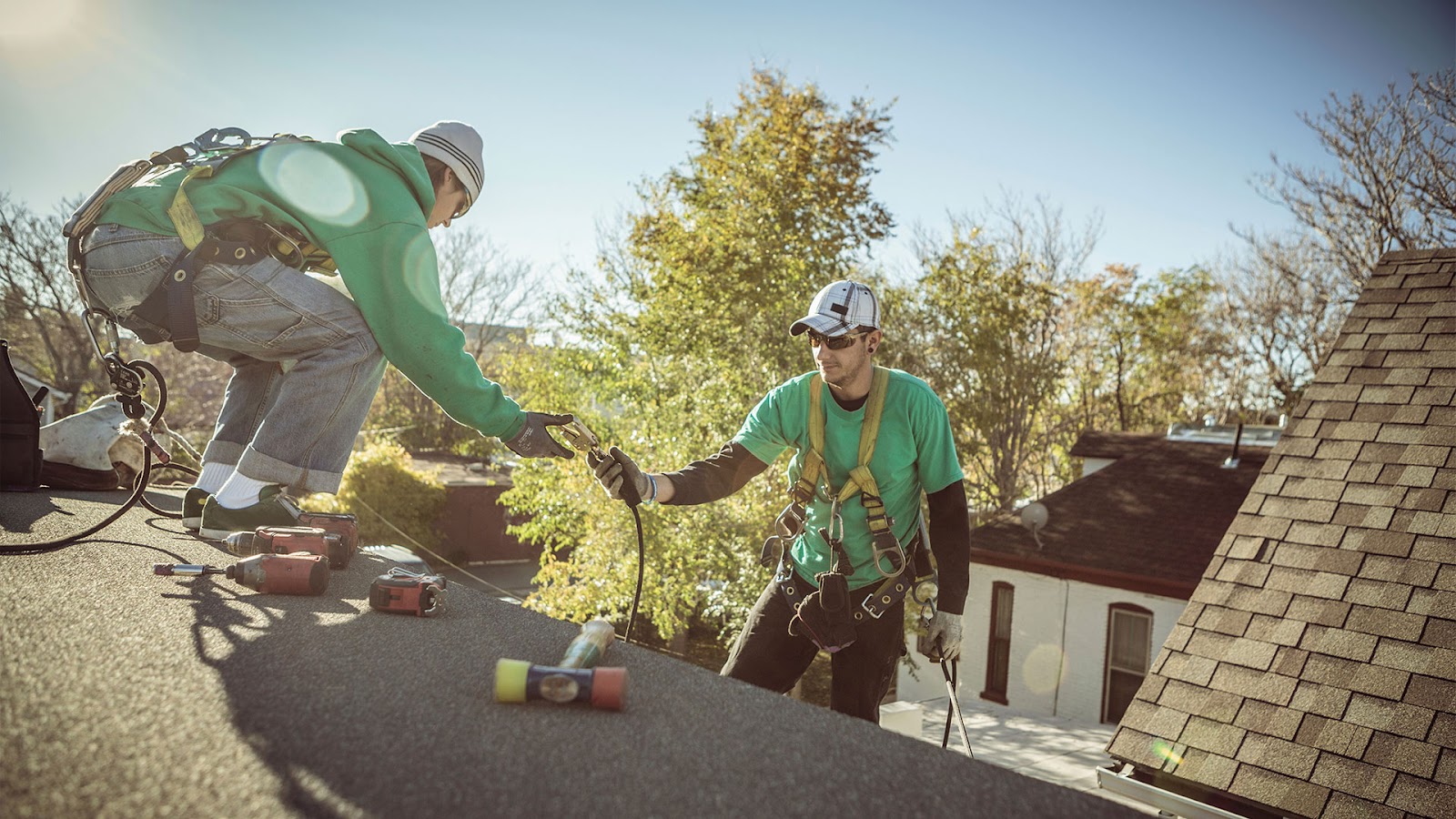 A professional contractor performing a roof inspection, checking shingles and flashing for damage to prevent costly repairs