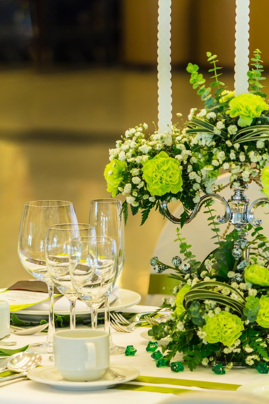 Outdoor wedding ceremony styled with olive green decor, featuring a minimalist greenery wedding arch with olive branches, eucalyptus, and soft white florals, creating an earthy and sophisticated atmosphere.