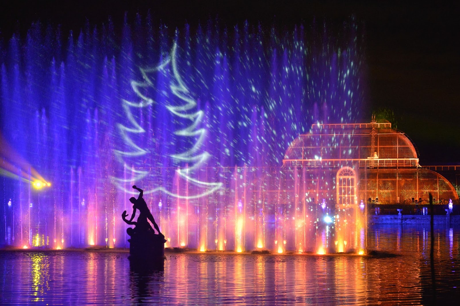 Magical Christmas light display at Kew Gardens in London, featuring colorful lights and festive decorations illuminating the winter night