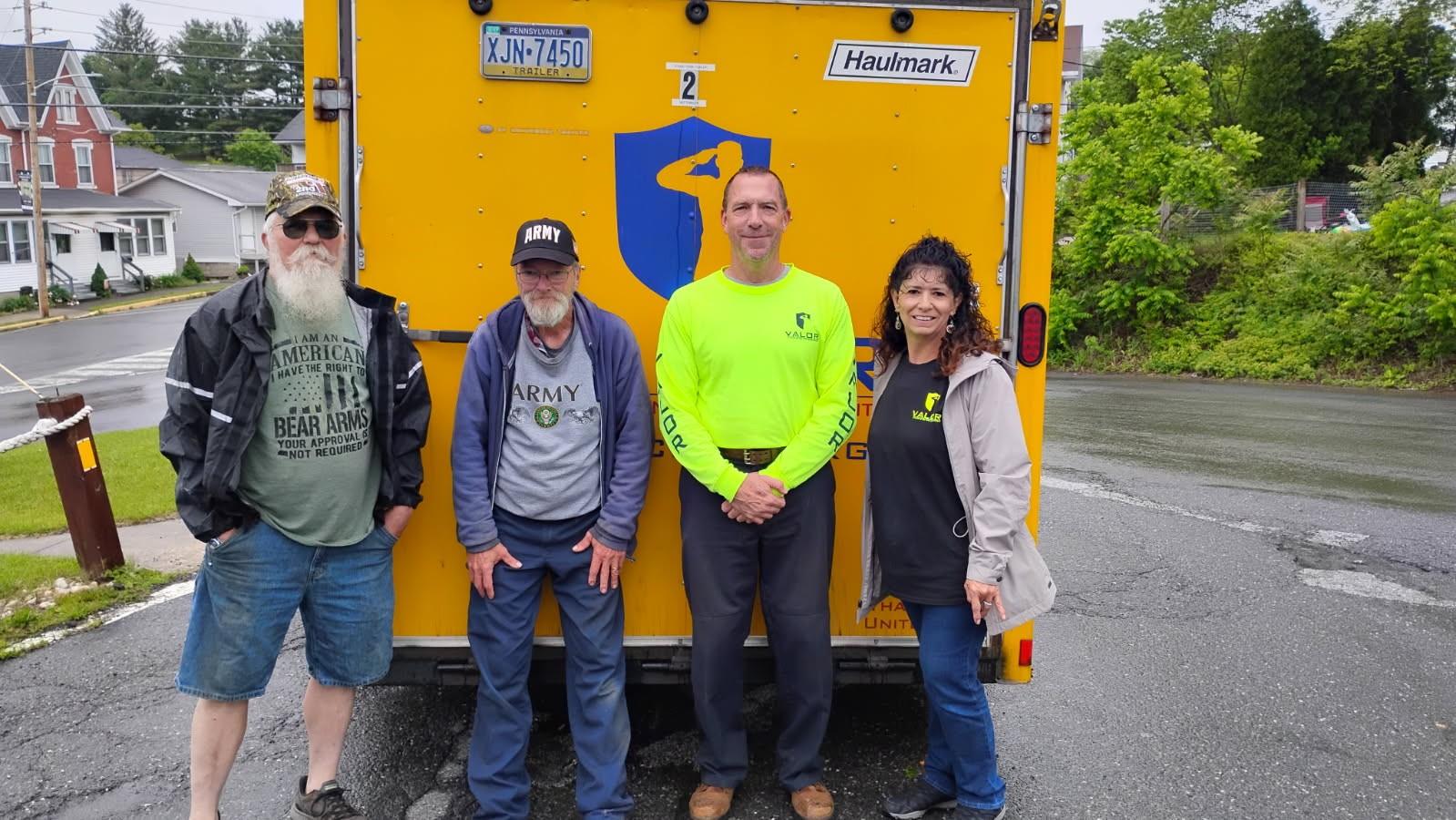 A group of people standing in front of a yellow truck

AI-generated content may be incorrect.