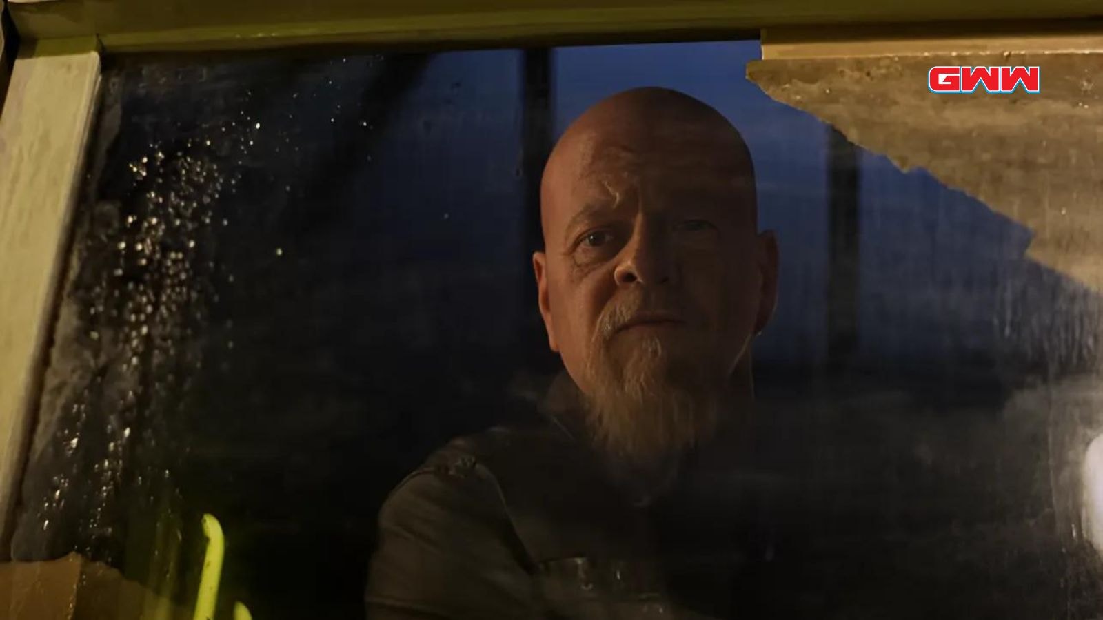 Michael Cudlitz as Lex Luthor, seen through a rain-splattered window