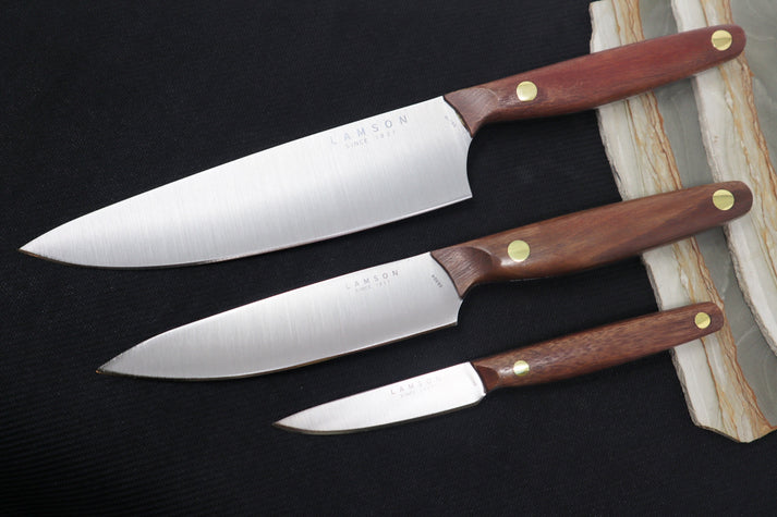 An image showing a Lamson chef's knife set. The knives feature high-quality stainless steel blades and a sleek, polished finish.